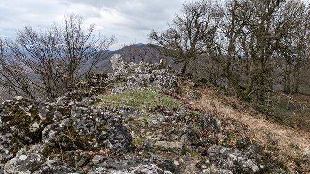 Rocky summit of a hill with the bench on highest point.