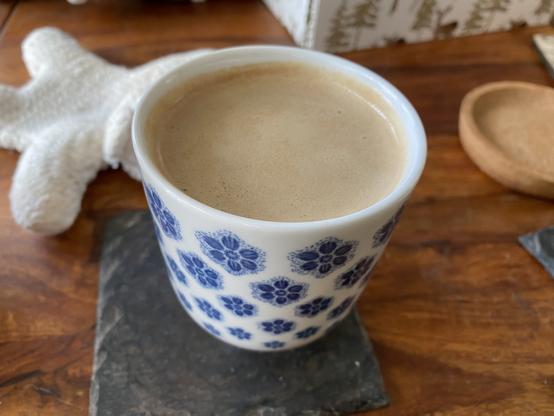 Oatmilk latte in a small Ikea cup