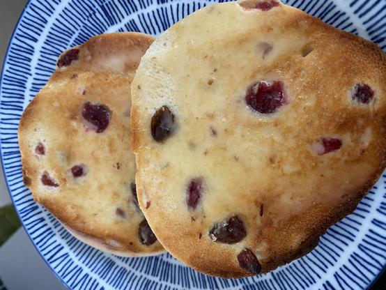 Cranberry and sultana homemade toasted teacake with hemp hearts and flax seeds and a small amount of avocado oil spread on top.