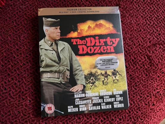 A photo of the “premium collection” edition of the war movie The Dirty Dozen. The cover is a photo of main star Lee Marvin, the movie’s title and an action scene plus the names of the stars of the movie at the bottom.