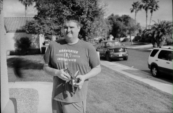Man standing in yard holding donkey figurine