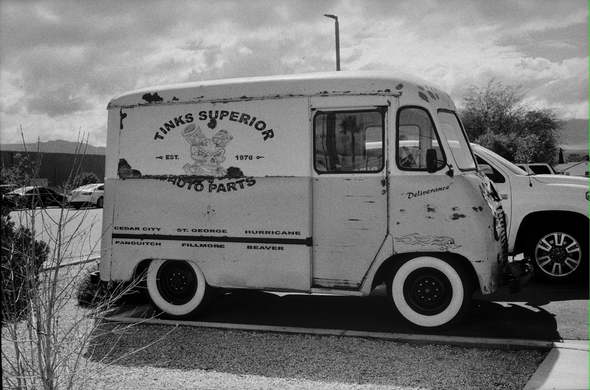 Old delivery truck in auto parts parking lot "tinks superior auto parts"