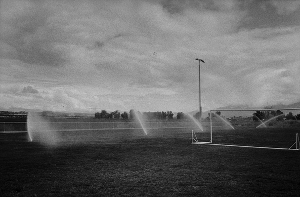 Sprinklers runnin in empty soccer field