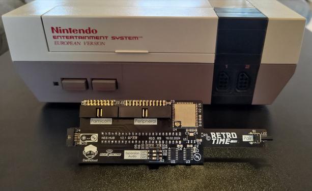 A Nintendo Entertainment System, European Version sits on a table next to the NES hub.