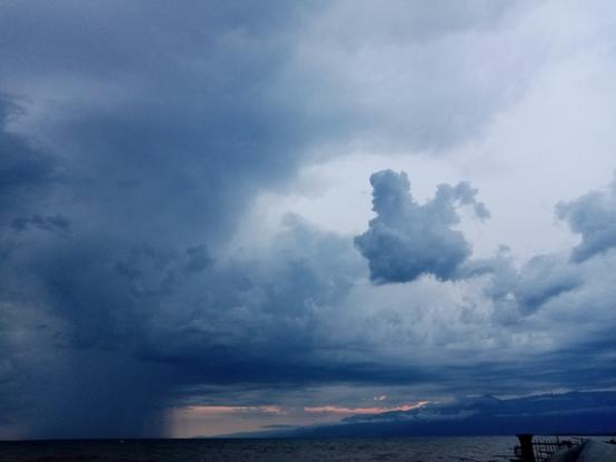 Sunsubiro super la Tanganjika lago. La ĉielo estas minacanta