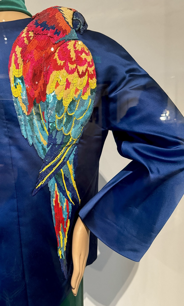 closeup of the large parrot (scarlet macaw) appliqué on shoulder of Oscar de la Renta blue jacket from ensemble