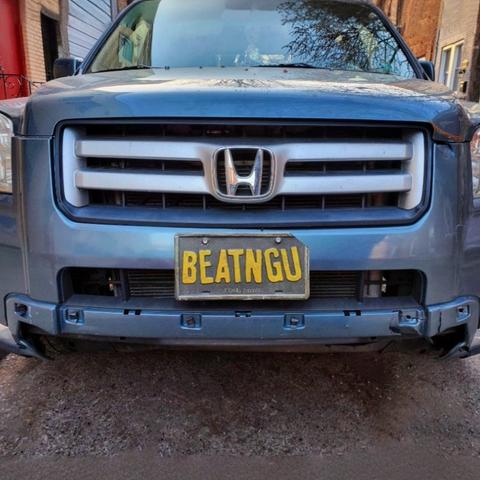 SUV with a vanity plate that reads "BEATNGU", the same license plate on the monster truck used by The Creeper in the 2001 horror film, Jeepers Creepers.