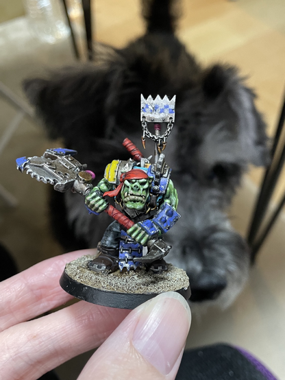 Ork space pirate figure with a cute miniature schnauzer in the background