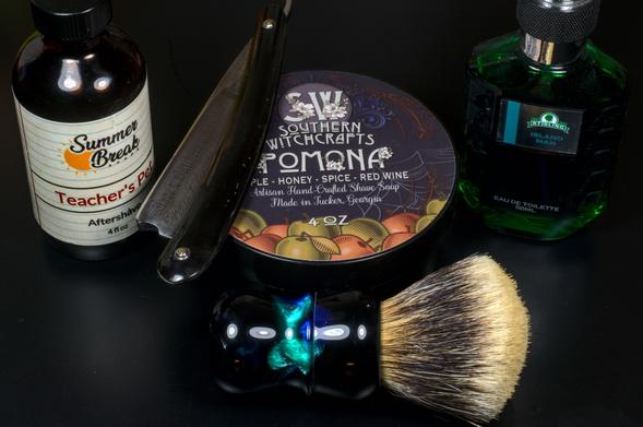 A Wade & Butcher wedge on a tub of SW Pomona soap surrounded by a bottle of SBS Teacher's Pet splash, Stirling Island Man frag, and a Dogclaration B3 brush