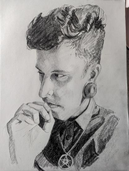graphite drawing of a man, wearing a black button up shirt with a pentagram necklace. He is pensively resting his finger against his lips, as he looks to the viewer's left.