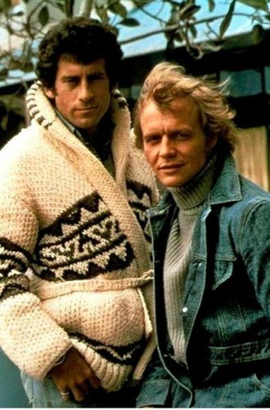 Starsky and Hutch from TV. Hutch (David Soul) is in denims and Starsky (Paul Michael Glaser) in his trademark ivory wool knitted cardigan with high collar and geometric pattern