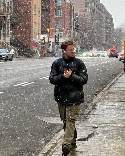 Street scene, man walking in snow fall