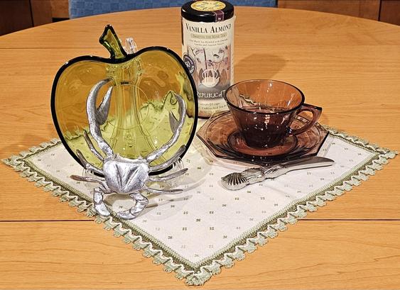 A tea tableau of a crab & apple, with Vanilla Almond black tea from Republic of Tea