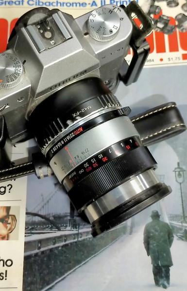 Camera and lens as described, on top of Popular Photography magazine from January 1984