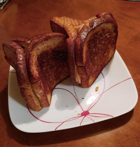 grilled cheese made with 3 bread in a triangular formation