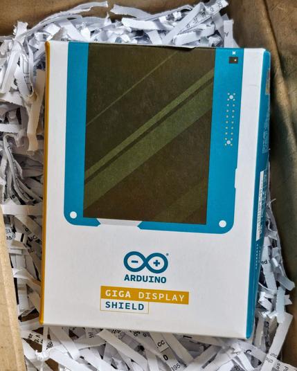 The Arduino GIGA Display Shield, in product packaging, inside a larger box
