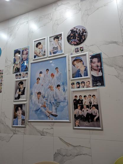 gallery wall of framed photos of Stray Kids