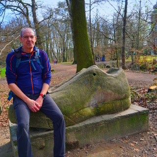 Ich, der ich auf der Skulptur eines Sneakers sitze.