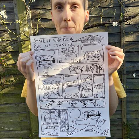 A photo of a real-life action dork 🙂 holding a comic layout page.