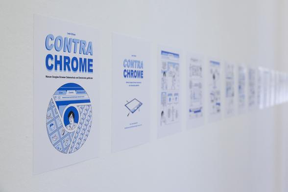 A photograph of a white wall with printed-out pages from my comic Contra Chrome. Held in blue and white, they form a line on the wall.