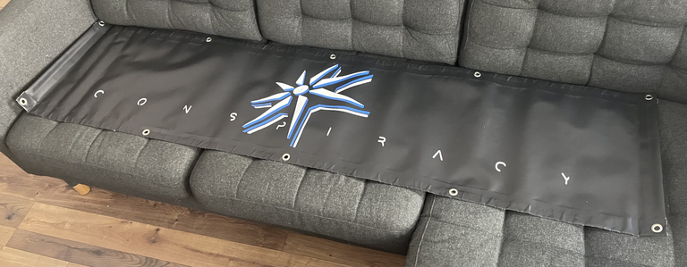 A large banner featuring the Conspiracy logo