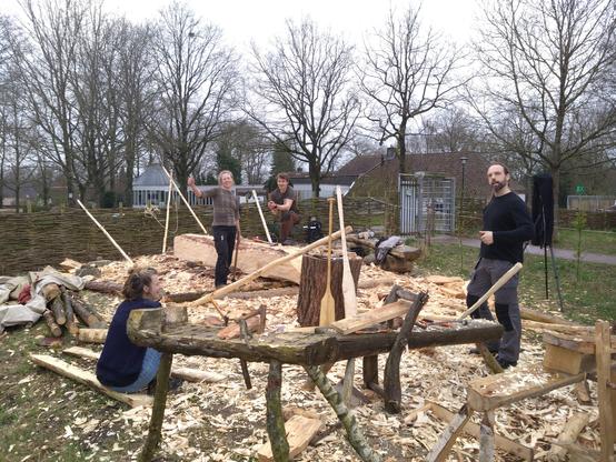 Een boomstam, uitgehakt. Vier harde werkers er omheen. En enorme hoeveelheden woodchips op de grond.