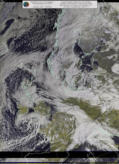 Satellite image showing cloud formations over a region with outlines of countries, technical details about the satellite and reception in upper right corner.