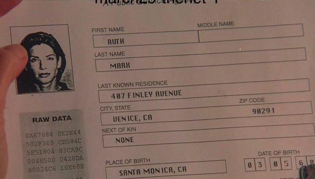 A printout from the Department of Motor Vehicles showing a driver’s license info page with a photograph of a woman with brown hair. The name on the file is Ruth Marx.