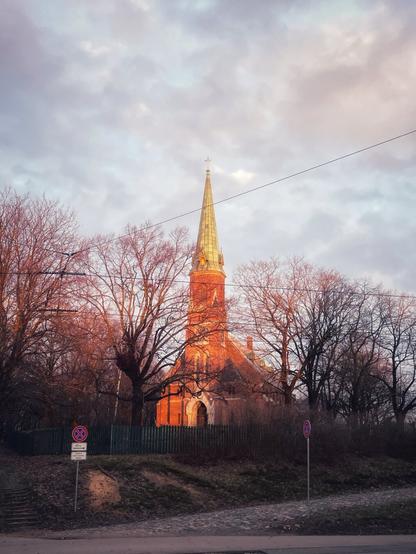 A red bricked church in a sunset