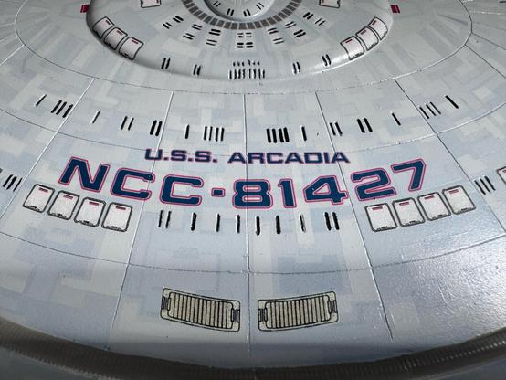 Closeup of the top of the model showing the name USS Arcadia and registry NCC-81427
