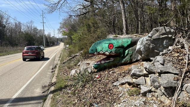 Green roadside monster painted rock