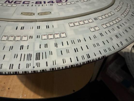 Closeup of the front of the saucer section showing the off windows with black ink in them.