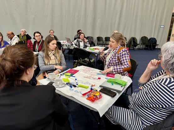 Workshop participants share their doodled ideas and notes over the microphone