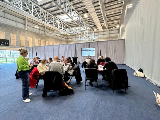 Workshop facilitator checks in with the tables