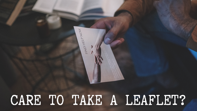 A stock image of someone holding a leaflet. The post title “care to take a leaflet?” is written across the bottom
