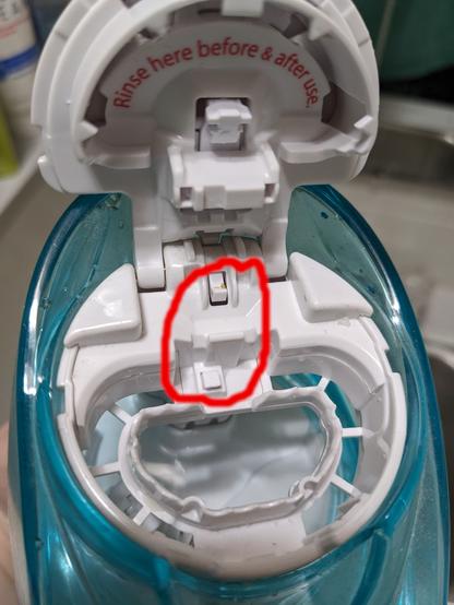 Close shot of the Navage's opened filling port on the top of the device. A crudely-drawn red circle shows the location of the two interlock switches. This interlock is intended to force use of the manufacturer's single-use "salt pods", however it can be easily defeated to allow use of bulk saline.