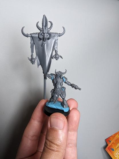 An unpainted beastman Iconarch blue-tacked together
