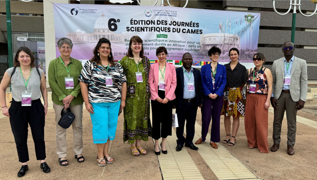 A group of people standing in front of a building. A poster of the congress JSDC-6 is seen in the background. From left to right: Dr. Ariane Düx, Prof. Dr. Doris Vetterlein, Dr. Valentin Marchese, Prof. Dr. Alena Rettová, Julia Bastong, Dr. Kennedy Wema, Dr. Kathrin Knodel, Dr. Denise Dekker, Prof. Dr. Stefanie Becker, Prof. Saturnin Enzonga Yoca.