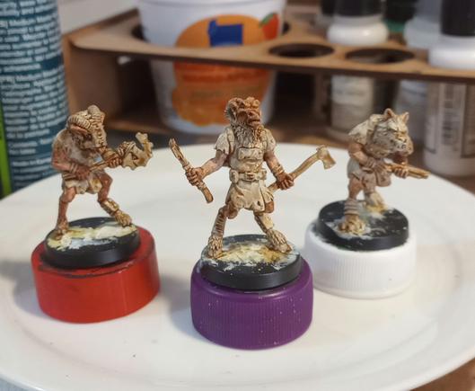 The same 3 animal/beast men miniatures, now with some flesh color on their...hides and drowned in Soft Tone Quickshade
