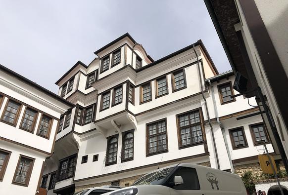 Ohrid architecture: a multifaceted building of brown wooden frames and white walls