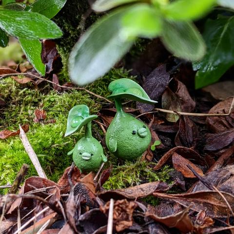 2 small korpokkur sculpts (little seedling balls) in a flower pot