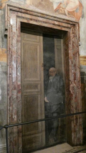 A painted figure appear to emerge from a painted door, to fool the onlooker.