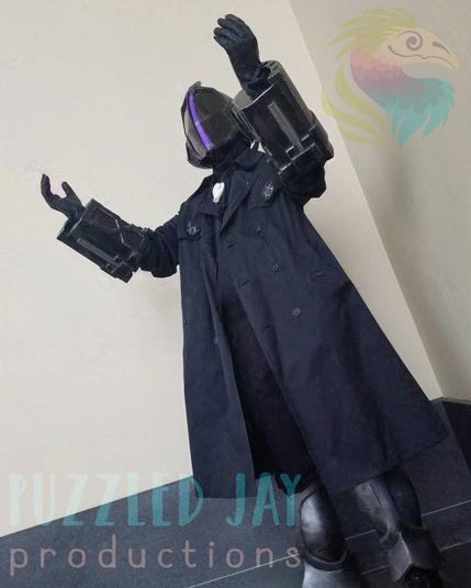Four pictures of a man cosplaying as Bondrewd from Made in Abyss. The character is dressed in a black overcoat with dark metallic gauntlets, greaves, and helmet. The helmet has a glowing, purple slit running vertically down the middle of the helmet.