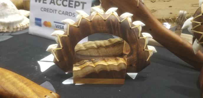 Hawaiian weapon made from wood and sharks teeth. It is shaped and meant to be held like a large set of brass knuckles.