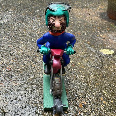 The same figurine. Now the goggles have been taken off and are resting on his helmet.