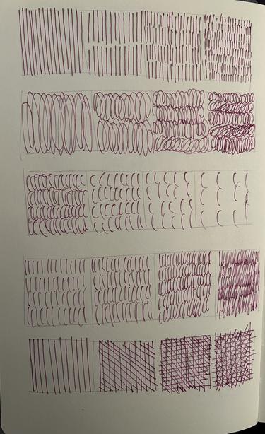 A paper with hand-drawn lines and shapes in red ink, showing various patterns and densities from straight lines to wavy lines and grids.