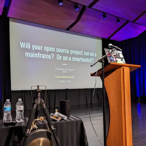 CPOSC Stage with a slide up that says "Will your open source project run on a mainframe? Or a smartwatch?"