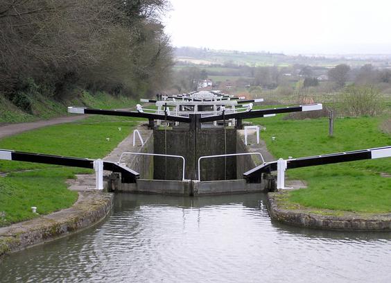 View over an array of canal locks, going downhill.