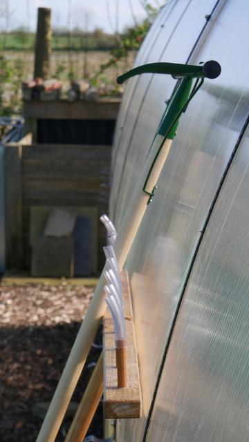 Comparison of the angles of a metal rake and the home-made wooden rake.