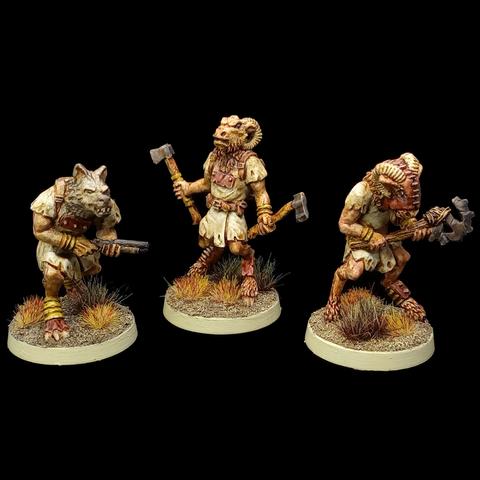 3 beastmen miniatures: there's a wolfman with a shotgun, a goatman with 2 axes, and another goatman wearing a mask and a makeshift weapon to smash heads in with (made with a stick and a broken cog). They're painted in tans and browns and generally have a post-apocalyptic wasteland look.